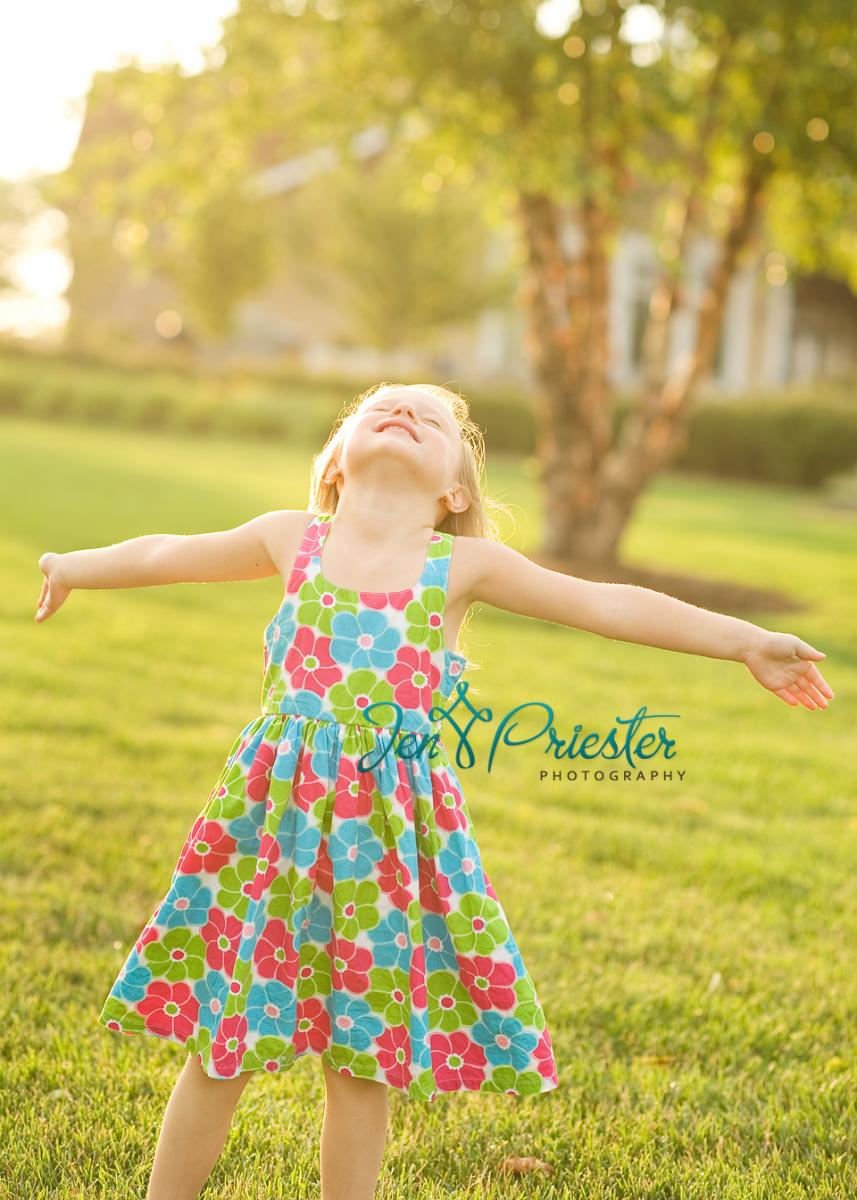 A girl in a field soaks up the sun