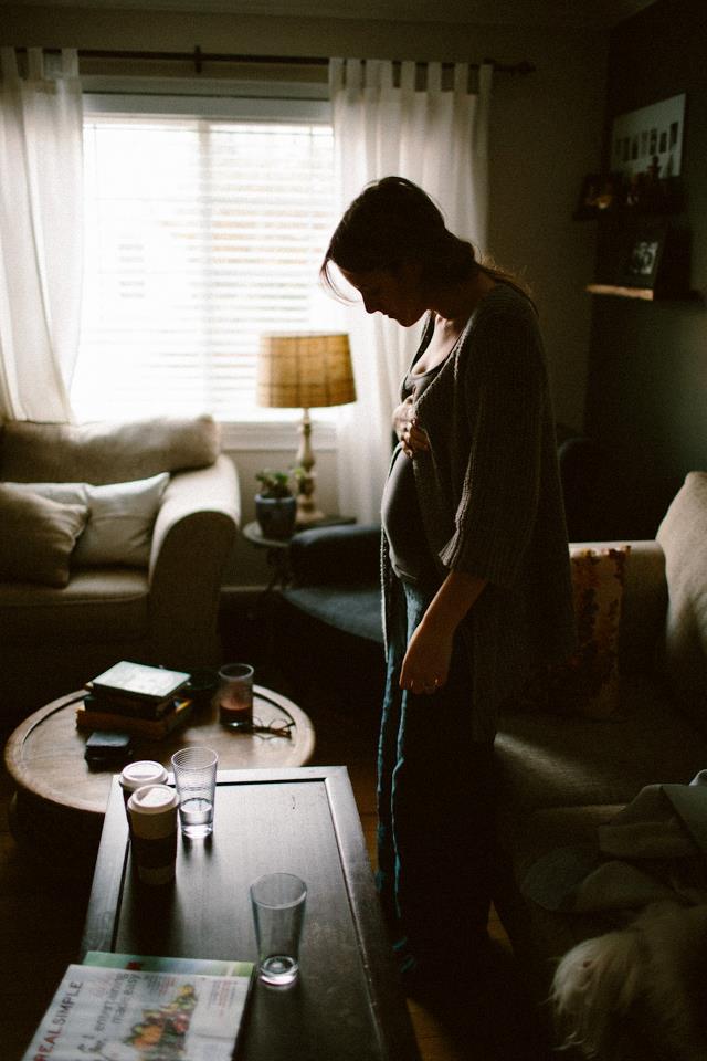 a pregnant woman standing in the light